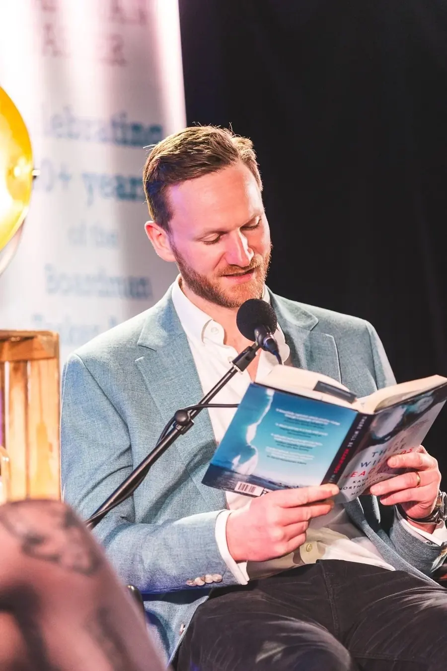 Mark Agnew reading from his book There Will Be Headwinds at a literary event